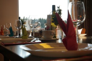 Enjoy a formal dining experience with fine tableware and a view of the outdoors.