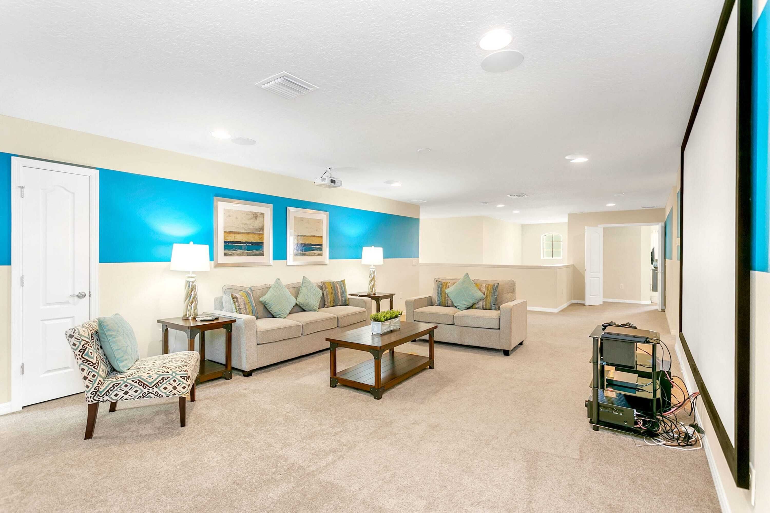 A living room with two sofas, a coffee table, and a patterned armchair.