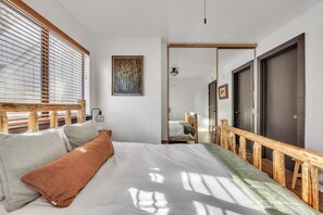A bedroom with a bed, wooden headboard, and a view of the hallway. - Alpine Retreat In The Heart Of Incline Village 2 Bedroom Condo (Incline Village)
