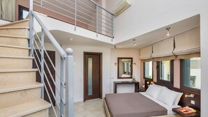 A bedroom with a bed, a nightstand, a mirror, a window with curtains, a staircase, and a door. - Ohana Hotel (Kassandra)