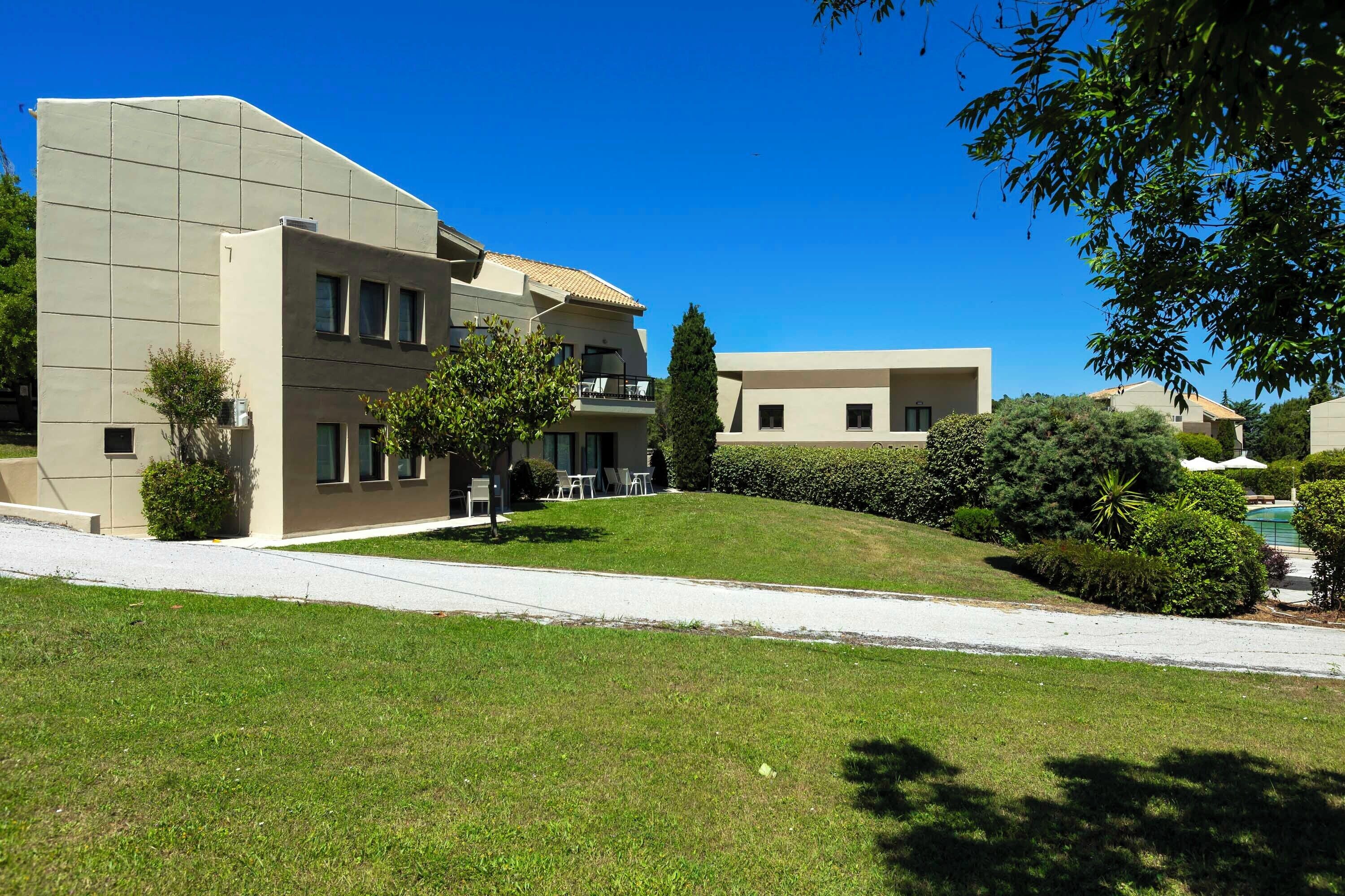 A modern building with a flat roof and a large window on the second floor.