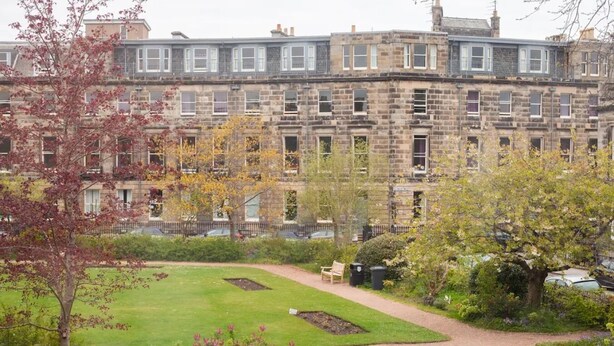 A traditional stone building with multiple windows and a well-maintained lawn in front. - Location! Location! Location! A Golf Lover’s Dream (St Andrews)