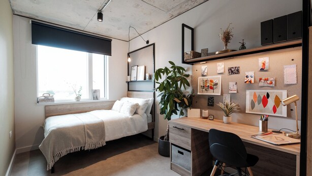 A compact bedroom with a bed, a desk, and a large window. - Student Only Old Kent Road (London)