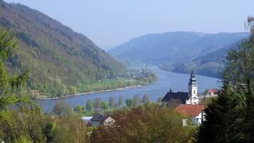 A river valley with a church and residential buildings.