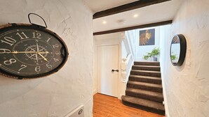 A staircase with wooden steps and a white door at the top. - Dove Cott | Sleeps 4 | Central Location (Croyde)
