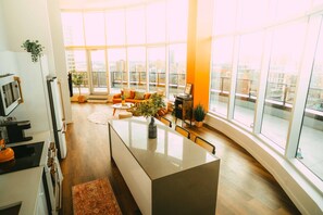 A modern kitchen with a central island, large windows, and a view of the city. - *Penthouse* - Luxe Stay with Views - Free Parking (Halifax)
