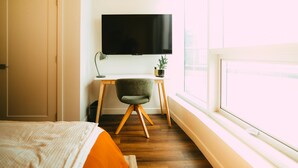 A bedroom with a bed, a desk with a chair, a television, and a window. - *Penthouse* - Luxe Stay with Views - Free Parking (Halifax)