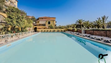 Seasonal outdoor pool, open 9:00 AM to 7:00 PM, pool umbrellas