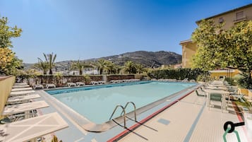 Seasonal outdoor pool, open 9:00 AM to 7:00 PM, pool umbrellas