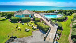 A resort with a pool, a deck, and a view of the ocean. - Almost Oceanfront 3 Bedroom Pebble Beach C-304 Condo (Emerald Isle)