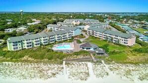 A coastal hotel with multiple buildings, a swimming pool, and a beach area. - Almost Oceanfront 3 Bedroom Pebble Beach C-304 Condo (Emerald Isle)
