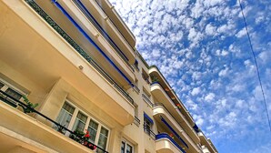 Ein mehrstöckiges Hotel mit Balkonen, großen Fenstern und blauem Himmel.