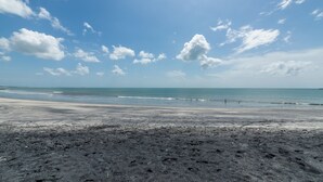 A beach with a clear sky and calm sea.