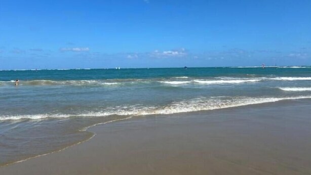 A beach with clear skies and calm waves. - Wind Chimes-Condo in Cabarete DR (Cabarete)