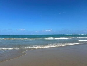 A beach with clear skies and calm waves. - Wind Chimes-Condo in Cabarete DR (Cabarete)