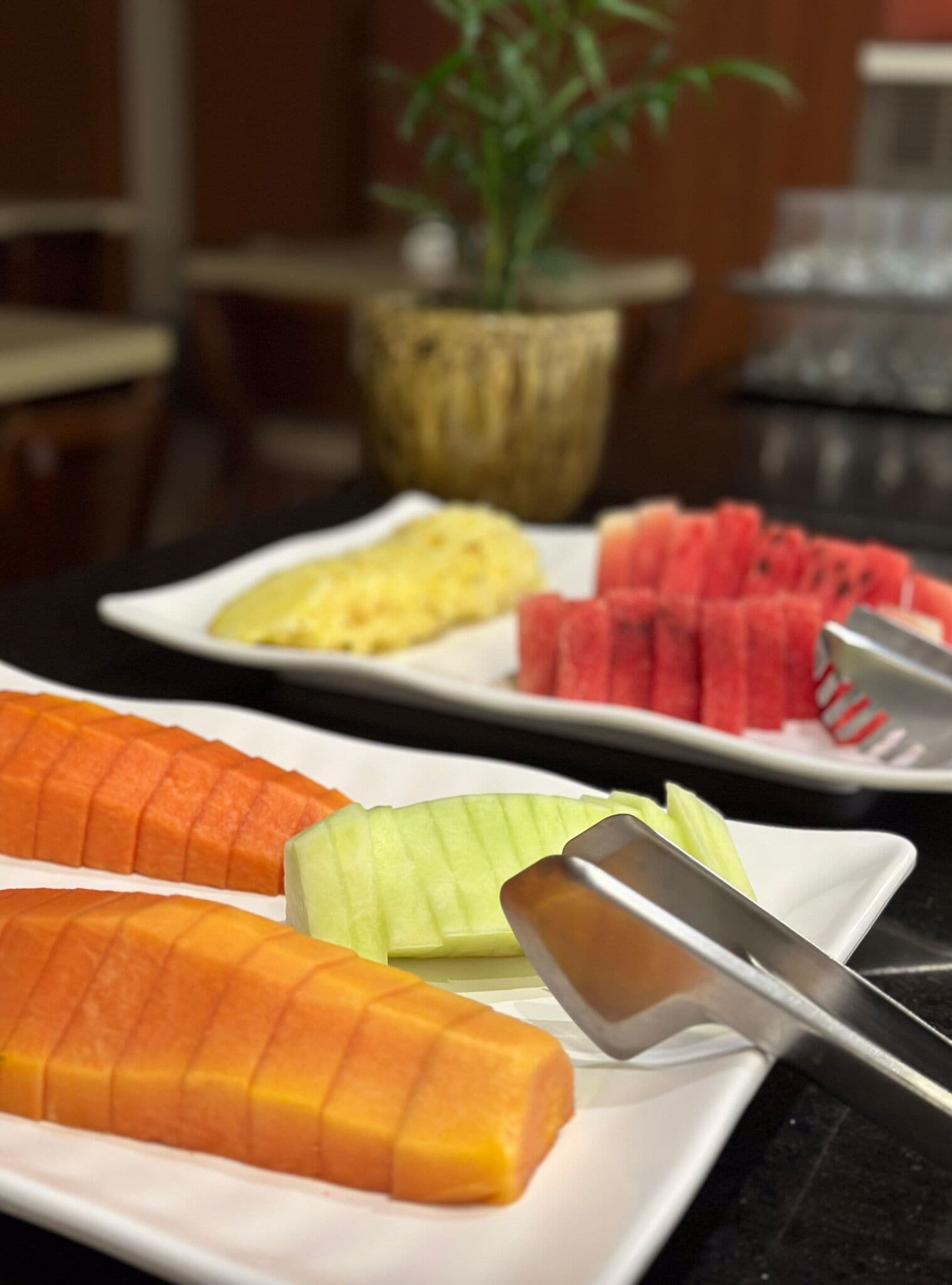 A table with various fruits and a knife.