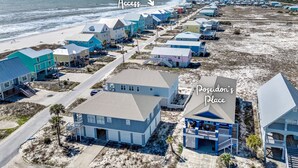 A coastal residential area with houses and a beach access point.