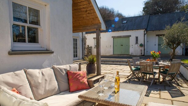 An outdoor seating area with a wicker table, a sofa, and chairs. - Ol y Don, Newport - Three Bedroom Cottage, Sleeps 6 (Newport)