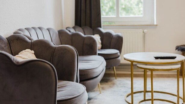 A living room with a sofa set and a small round table.