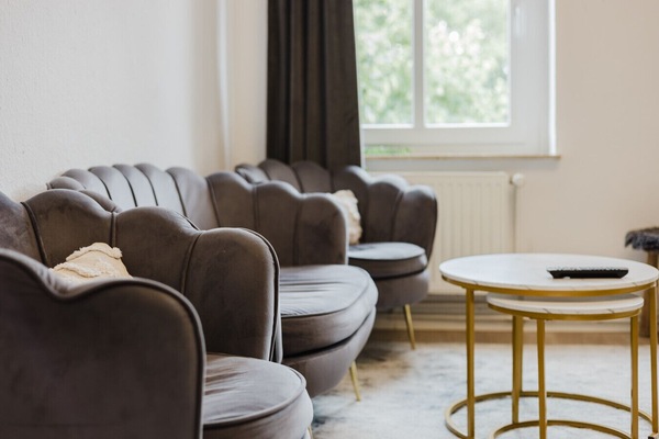 Unwind in this stylish velvet seating corner with a serene view.