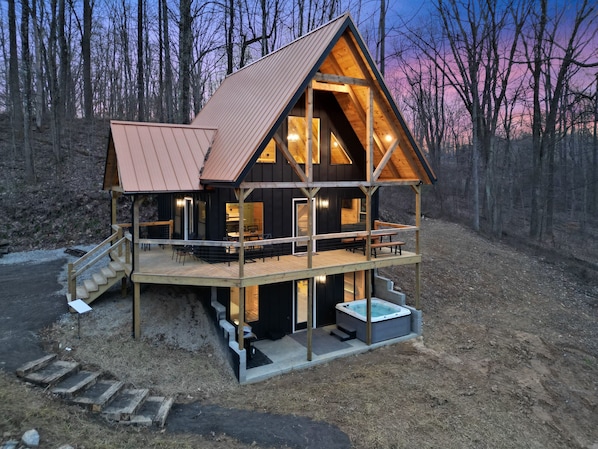 A cabin with a wooden exterior, a balcony, and a hot tub. - Timberline Retreat | Hocking Hills, Hot Tub (Creola)