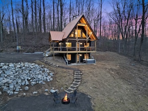 A wooden cabin with a metal roof, a fire pit, and outdoor seating. - Timberline Retreat | Hocking Hills, Hot Tub (Creola)