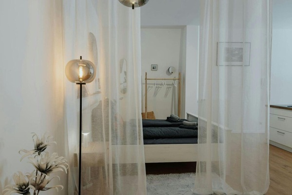 The large bed, separated by breathable curtains.