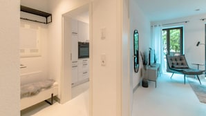 A modern kitchen with white cabinets and a built-in oven.