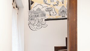 A wooden staircase with a hand-drawn map on the wall above it. - Studio Secundo (Metz)