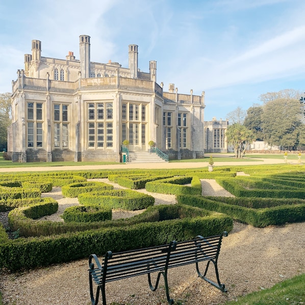 A historic building with a symmetrical facade, large windows, and a central staircase leading to the entrance. - Sea Dreams - a pet friendly property on Sandhills (Christchurch)