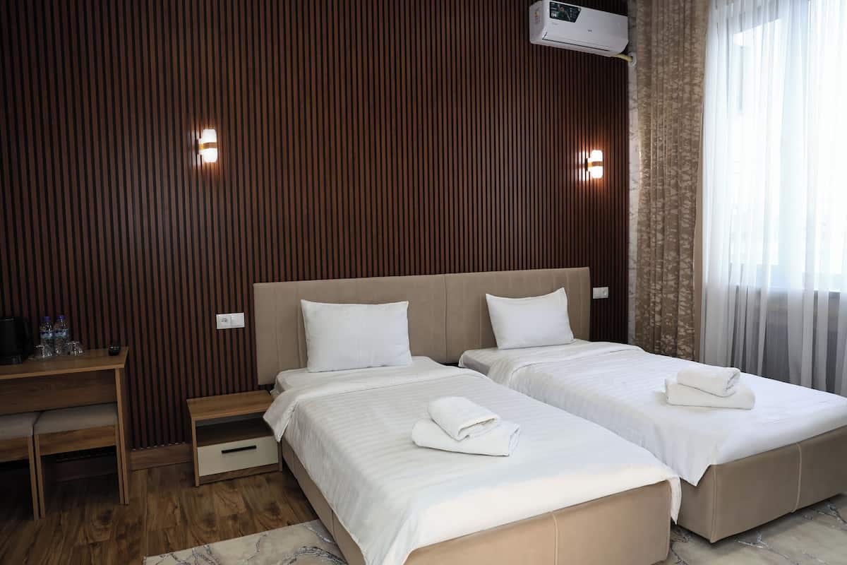 Hypo-allergenic bedding, desk, laptop workspace, blackout curtains