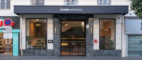 A hotel entrance with a black awning, a glass door, and a sign indicating a 40-minute maximum stay.