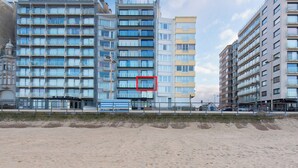 A multi-story hotel with a modern architectural design, featuring balconies and large windows. - Apartment in Middelkerke With Sea View (Middelkerke)