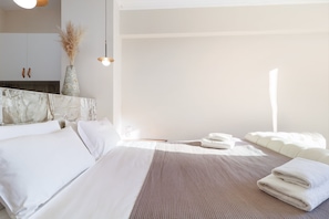 A modern hotel room with a large bed, a bedside table, and a view of the city. - Monastiraki 507 Superhost Hub (Athens)