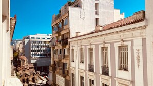 A narrow street with historic buildings, including a building with a sign for 'Sun Lounge'. - 305 Monastiraki 305 Superhost Hub (Athens)