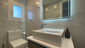 A modern bathroom with a large mirror, a toilet, and a sink. - Monastiraki 512 Superhost Hub (Athens)