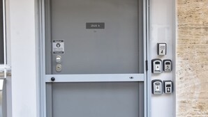 A hotel entrance with a closed door labeled "ZEUS A" and a security keypad to the right. - Athens Zeus A by Super Host Hub (Athens)