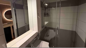 A modern bathroom with a glass shower enclosure, a large mirror, and a vanity with a sink. - Monastiraki 304 Superhost Hub (Athens)