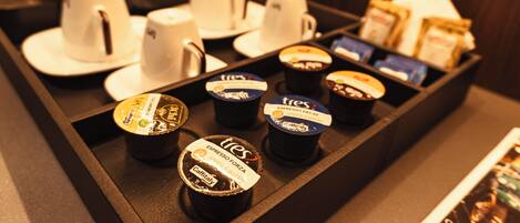 A coffee station with various coffee cups and containers, including espresso and latte options.