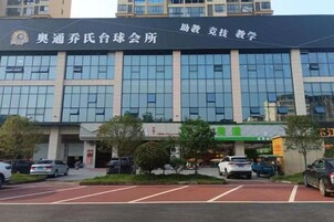 A building with a sign reading '奥通乔氏白球会所' and '助教助学'.