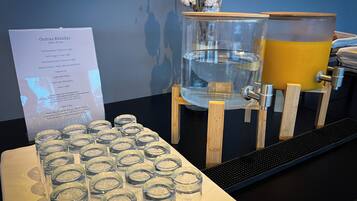 A coffee station with a menu board, a water dispenser, and a coffee machine.