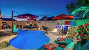 A backyard with a swimming pool, outdoor seating, a bar area, and a decorative light arch. - 5BR Hideaway w/ Heated Pool/Hot Tub/Billiards Table (Glendale)