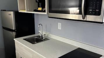 Full-sized fridge, microwave, stovetop, coffee/tea maker