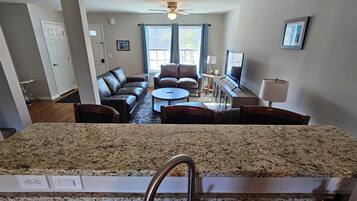 A kitchen with granite countertops, a stainless steel faucet, and a dish soap bottle.