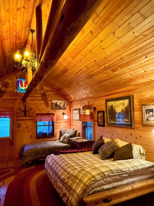 A cozy cabin-style bedroom with two beds, wooden walls, and a sloped ceiling. - Cozy cabin in Longmont, near to CU, CSU, UNC and RMNP. WiFi, AC (Longmont)