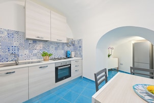 Deluxe Apartment, Partial Sea View | Private kitchen | Espresso maker, coffee/tea maker, electric kettle, cleaning supplies