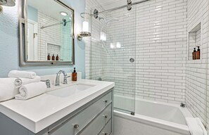 Shower, hair dryer, towels, shampoo