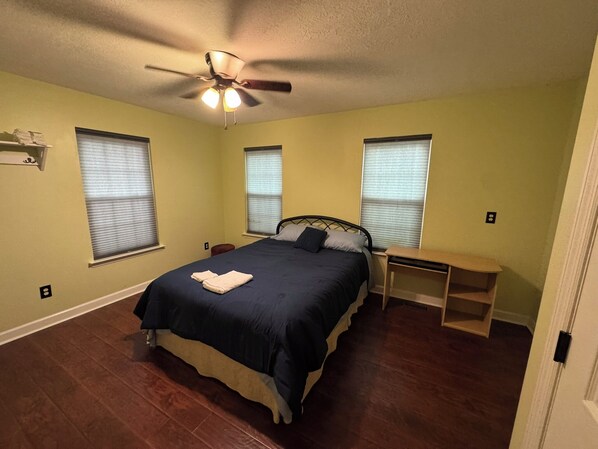 A bedroom with a bed, bedside tables, a ceiling fan, and windows with blinds. - Spacious 5-bdrm, 4bth with AC, WiFi, fenced yard, outdoor pool in charming Evans (Evans)