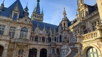 A historic building with ornate architecture, including a grand staircase and multiple spires.