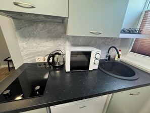 Fridge, microwave, cookware/dishes/utensils